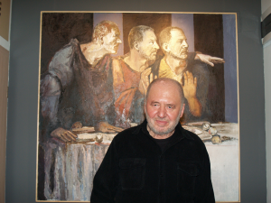 The artist Vanko Urumov standing in front one of his paintings.